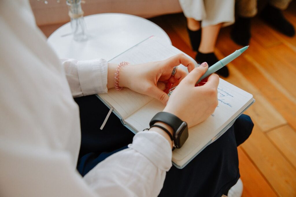 Therapist writes in a notebook during a counseling session